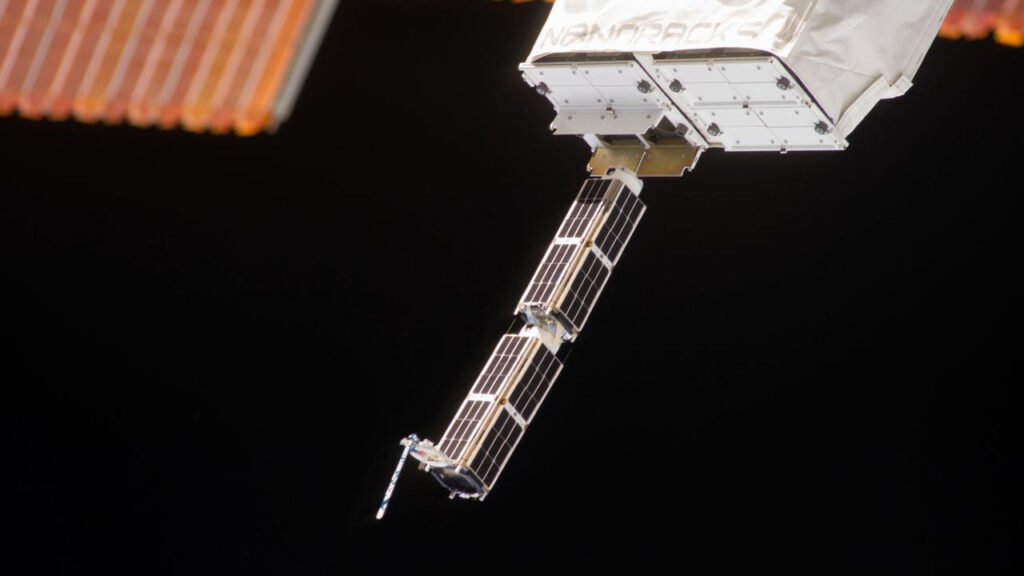nanoracks-cube-sats-deployed-nlra2023-8 The Small Satellite Orbital Deployer (SSOD), in the grasp of the Kibo laboratory robotic arm, is photographed by an Expedition 38 crew member on the International Space Station as it deploys a set of NanoRacks CubeSats. The CubeSats program contains a variety of experiments such as Earth observations and advanced electronics testing.