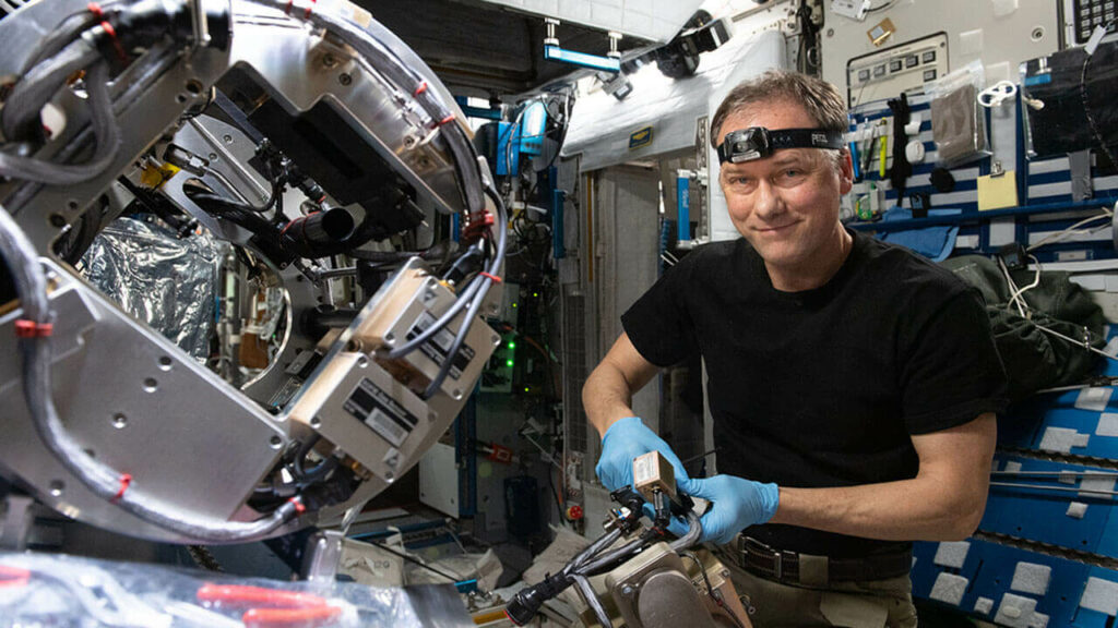 NASA astronaut Thomas Marshburn configures the Combustion Integrated Rack's combustion chamber for the Solid Fuel Ignition and Extinction study to investigate material flammability and ways to improve fire safety in space.