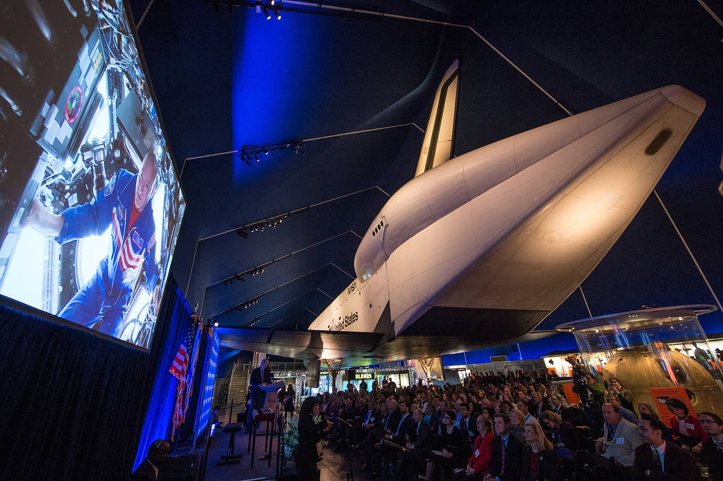 NASA astronaut Scott Kelly delivers remarks from onboard the International Space Station during the Space Shuttle Enterprise dedication ceremony Monday, April 27, 2015 at the Intrepid Sea, Air & Space Museum in New York City. Enterprise was dedicated to the fallen crews who gave their lives in pursuit of space exploration on the Apollo 1, Challenger, and Columbia space missions.