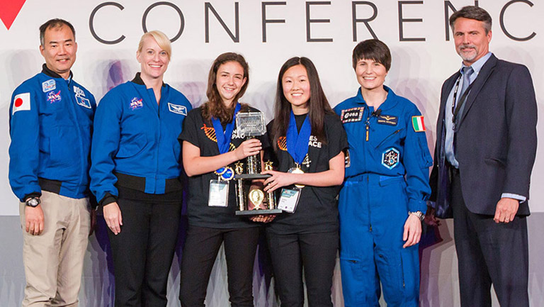 Elizabeth Reizis and Sophia Chen with Astronauts Kate Rubins, Samantha Cristoforetti, and Soichi Noguchi and Mark Mulqueen of Boeing.