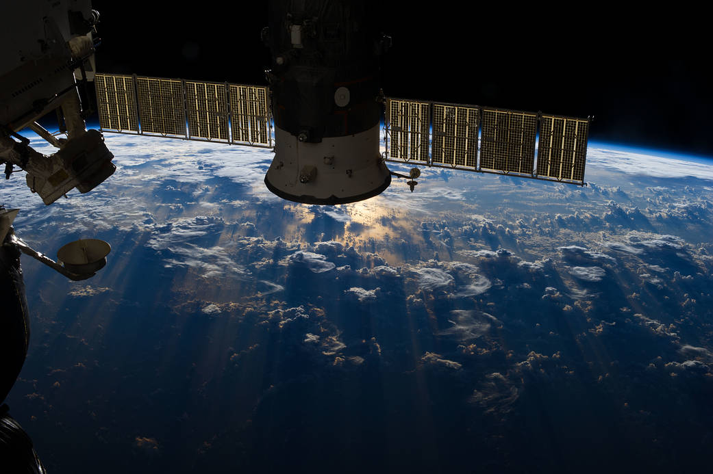 One of the Expedition 36 crew members aboard the International Space Station used a 50mm lens to record this image of a large mass of storm clouds over the Atlantic Ocean near Brazil and the Equator on July 4, 2013. A Russian spacecraft, docked to the orbiting outpost, partially covers a small patch of sunglint on the ocean waters in a break in the clouds.