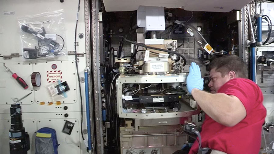 NASA Astronaut Bob Behnken works within the Light Microscopy Module facility on the Capillary Driven Microfluidics investigation from 1Drop Diagnostics, Inc.