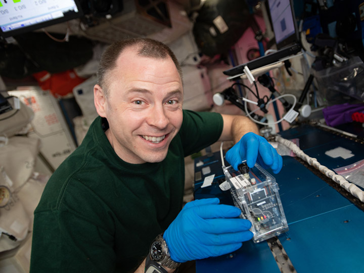 NASA astronaut Nick Hague works on the Genes In Space 6 experiment that is aimed at studying radiation damage to DNA.