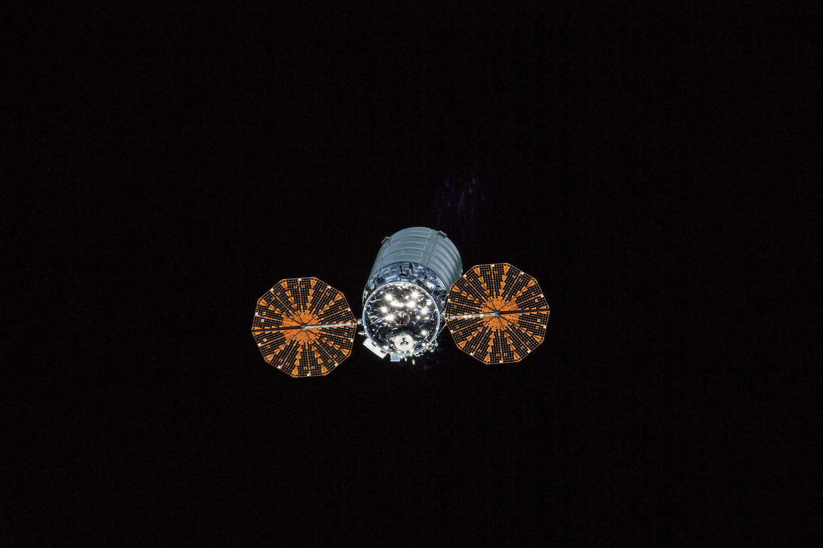 The Cygnus spacecraft with its cymbal like UltraFlex solar arrays deployed was pictured departing the space station Dec. 5, 2017 during Expedition 53.