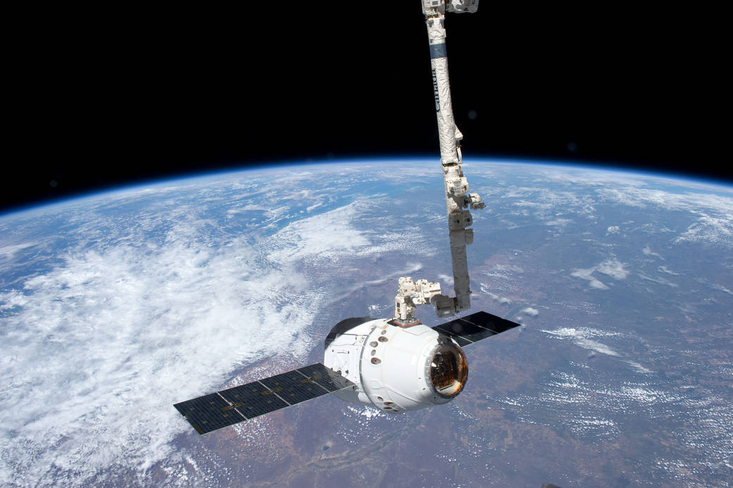 The SpaceX Dragon commercial cargo craft is grappled by the Canadarm2 robotic arm at the International Space Station. Dragon became the first commercially developed space vehicle to be launched to the station to join Russian, European and Japanese resupply craft that service the complex while restoring a U.S. capability to deliver cargo to the orbital laboratory.