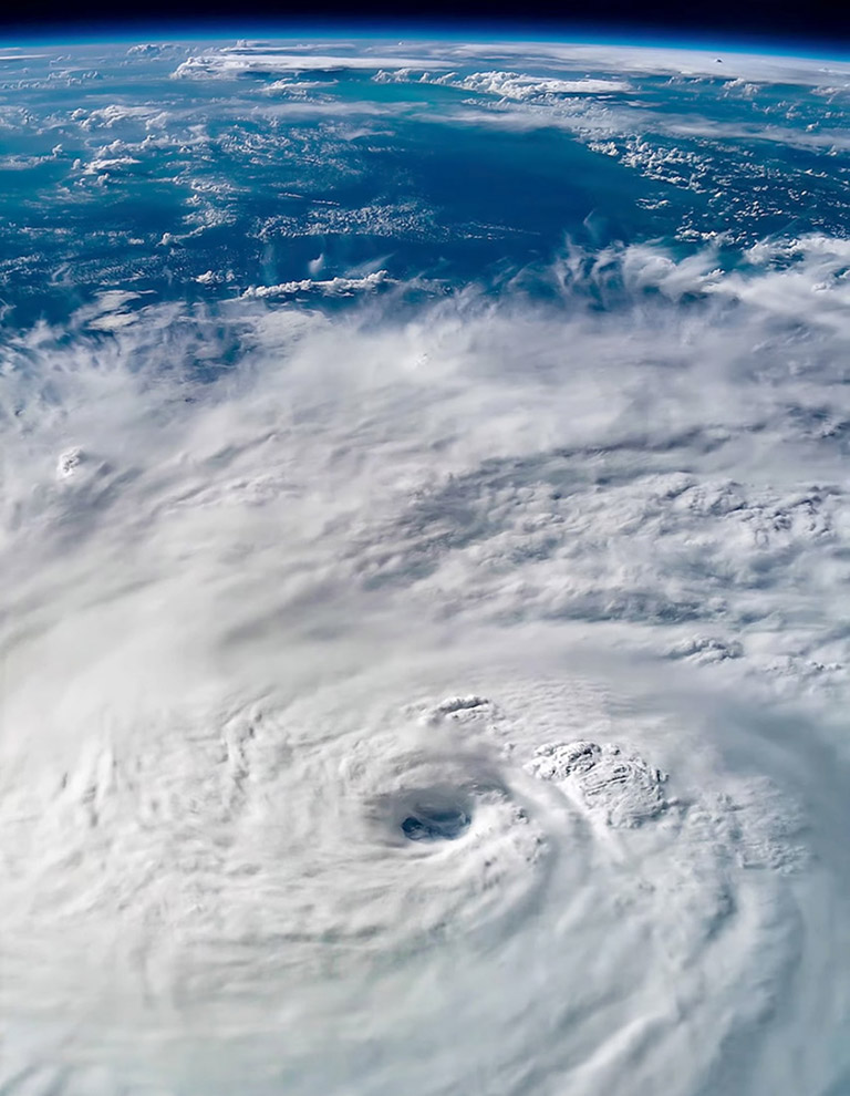 This is Tropical Cyclone Gita on February 13, 2018, not long after this Category 3 storm had passed Fiji. This view, which covers an area of 1,500 kilometers by 1,000 kilometers (930 miles by 620 miles), shows the spiral bands of the storm wrapping around a clearly visible eye. But unlike storms in the northern hemisphere that rotate counterclockwise, this southern hemisphere storm rotates clockwise! Large storms rotate because of the Coriolis effect, which results from Earths west to east rotation and spherical shape. Moving fluids (especially air) are deflected to the right in the northern hemisphere and to the left in the southern hemisphere. If Earth werent rotating, storms would move in straight lines and their bands of clouds would be shaped like straight spokes instead of spirals.