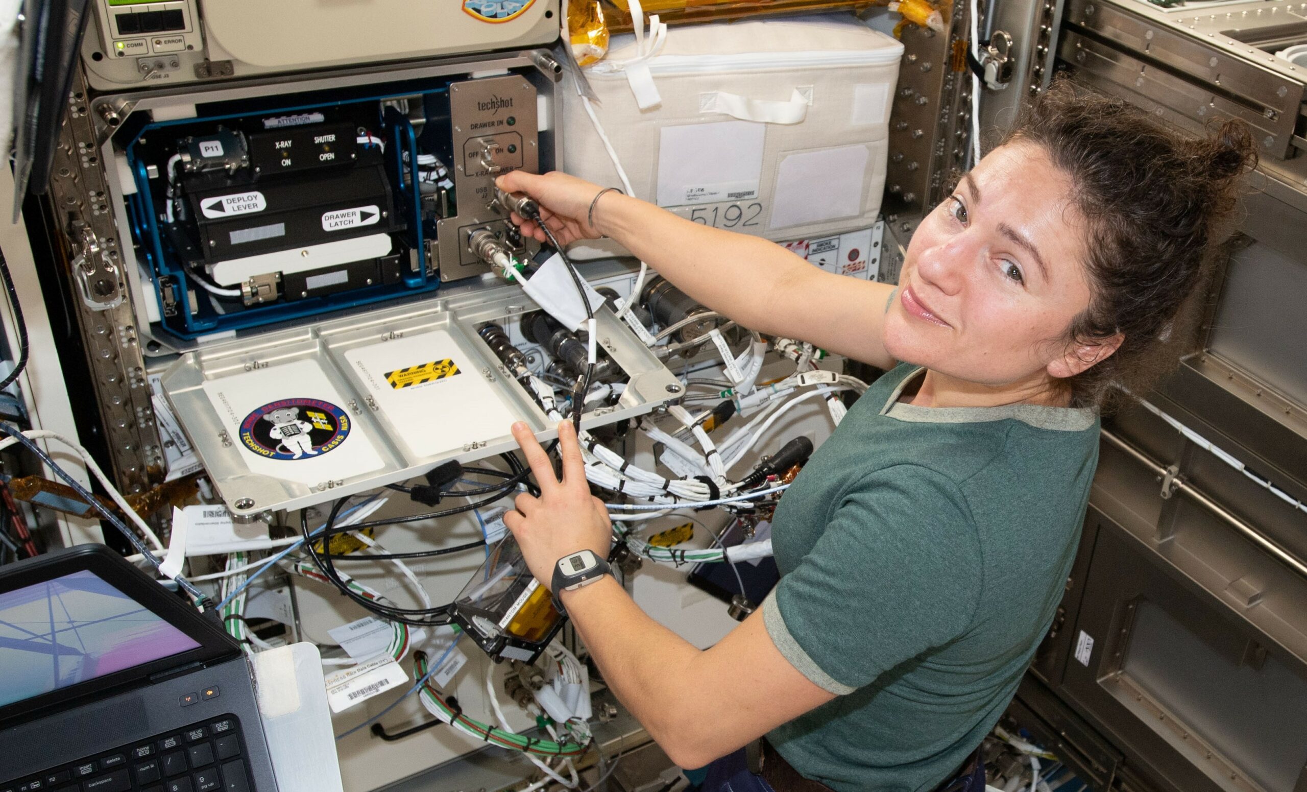 NASA astronaut Jessica Meir works with the Techshot Bone Densitometer to assess bone density of the animal subjects for the Mighty Mice investigation.