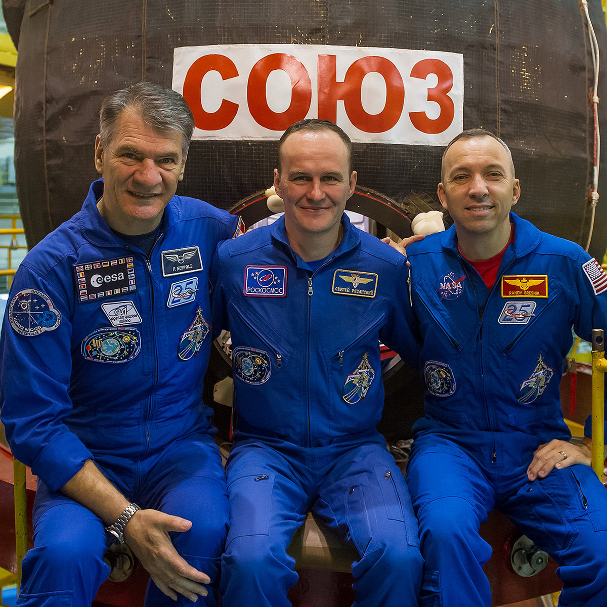 n the Integration Facility at the Baikonur Cosmodrome in Kazakhstan, Expedition 52 53 crewmembers Paolo Nespoli of the European Space Agency (left), Sergey Ryazanskiy of the Russian Federal Space Agency (Roscosmos, center) and Randy Bresnik of NASA (right) pose for pictures in front of their Soyuz MS 05 spacecraft July 17 as part of their fit check dress rehearsal activities.