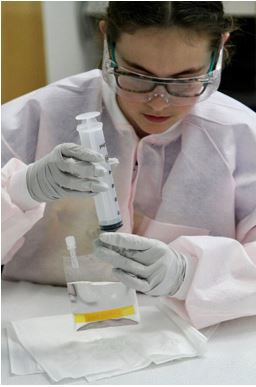 Payton Kelly Van Domelen prepares solutions for crystallization.