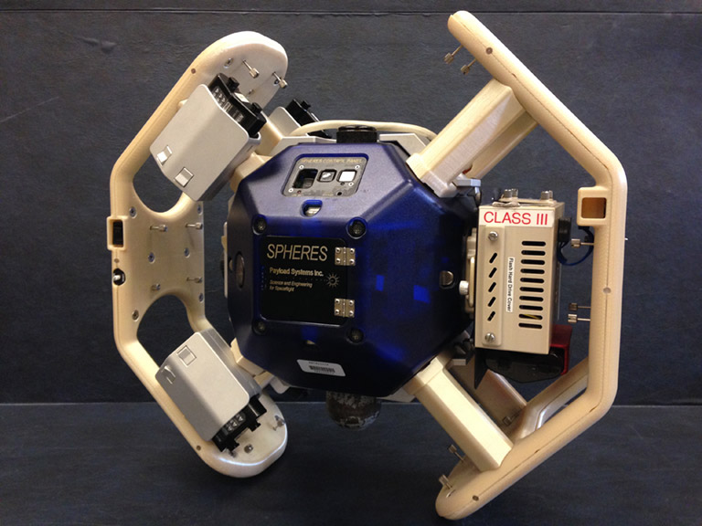 The robot called Blue was sent home in August 2016 for repair, then returned to ISS aboard a Dragon capsule in February 2017. Its shown here with the Halo attachment that supports multiple peripheral devices.
