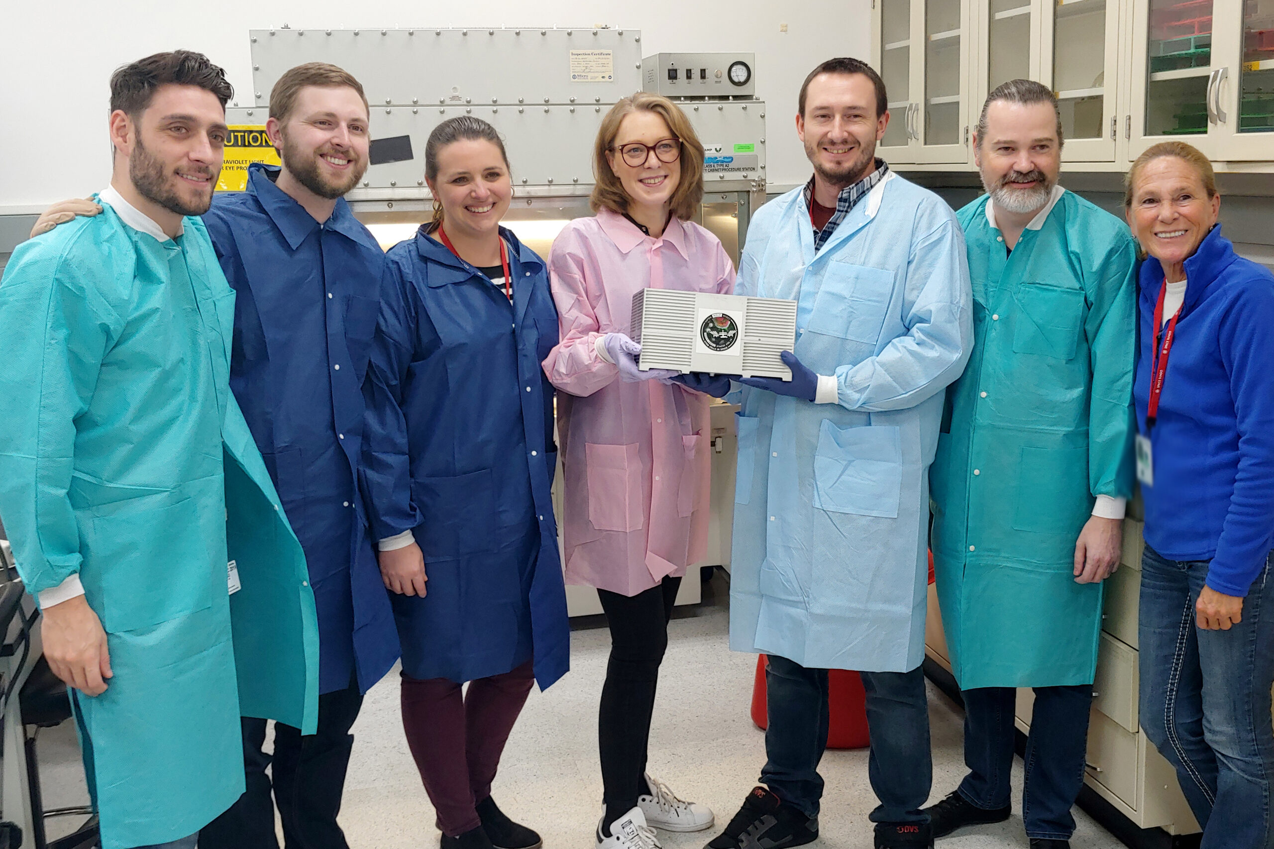 Team members from the Stem Cells in Space alliance closeout their CubeLab investigation at the Space Tango Space Station Processing Facility Lab prior to turnover for SpaceX CRS 19.