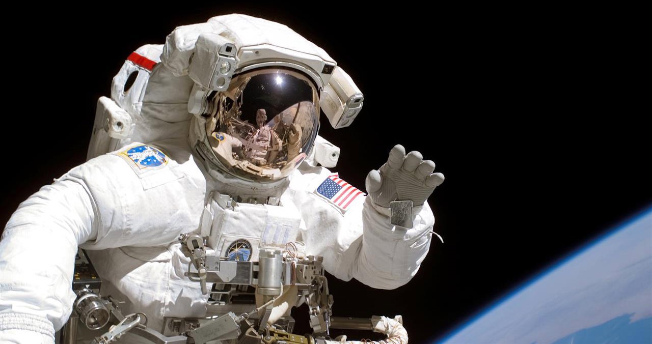 S115 E 05753 (12 Sept. 2006) Astronaut Joseph R. Tanner, STS 115 mission specialist, waves toward the digital still camera of his space walk colleague, astronaut Heidemarie M. Stefanyshyn Piper as the two share extravehicular activity (EVA) duties during the first of three scheduled spacewalks. The STS 115 astronauts and the Expedition 13 crew members are joining efforts this week to resume construction of the International Space Station.