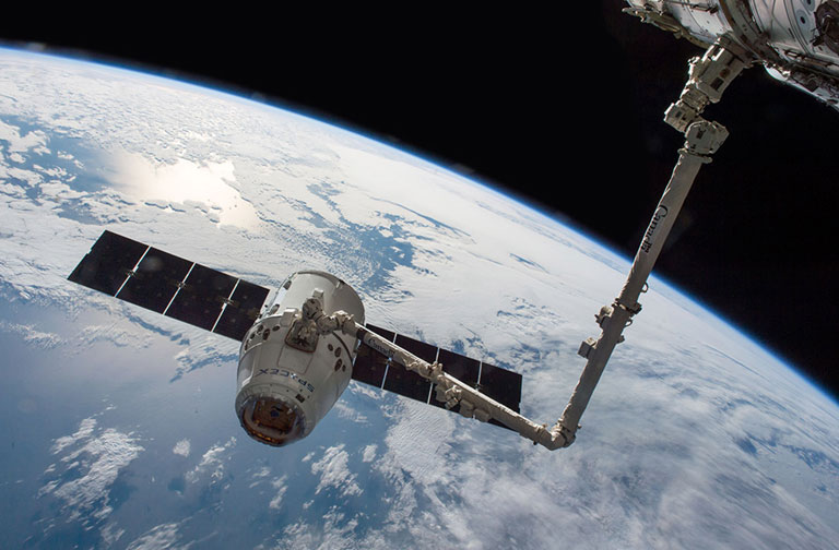 This photo from 2016 shows a SpaceX Dragon capsule with the Canadarm2 robotic arm attached.