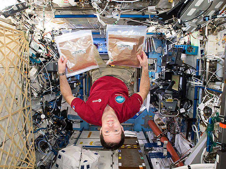 European Space Agency (ESA) astronaut Thomas Pesquet with 1.2 million Tomatosphere seeds that launched to the ISS on February 19, 2017.