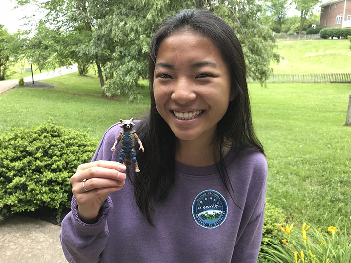 Adia Bulawa holds Rocket, the Guardians of the Galaxy Character that inspired her winning idea to test a UV activated dental glue on the ISS.