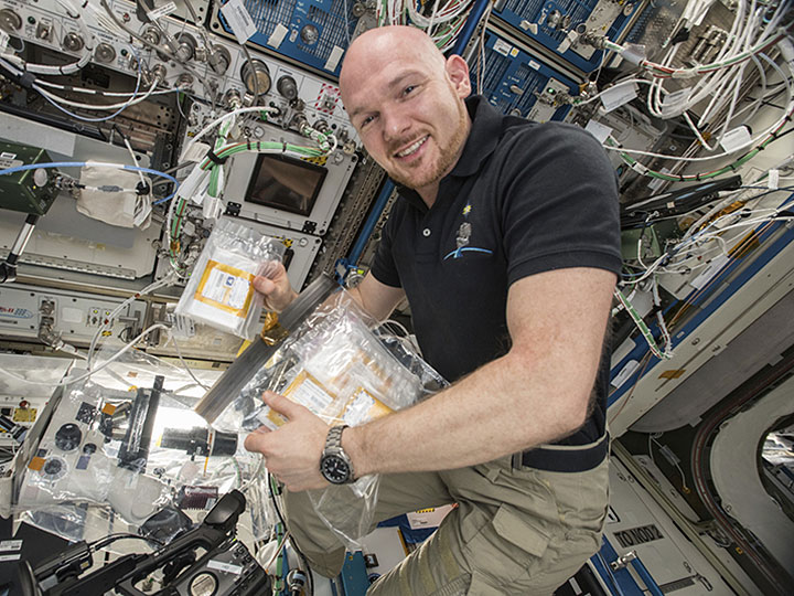 European Space Agency astronaut Alexander Gerst working on the KRAS protein crystallization experiment onboard the International Space Station.