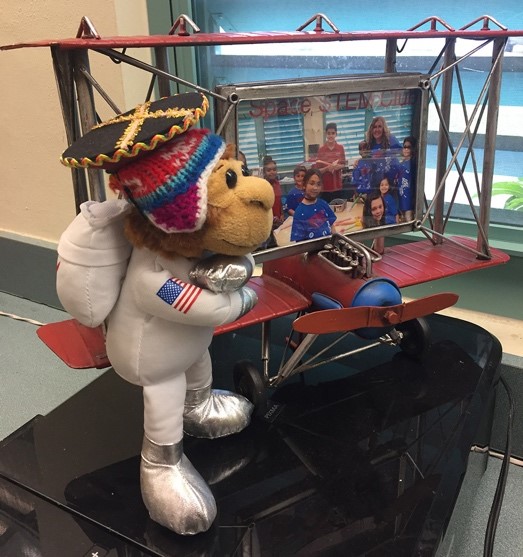 The mascot for the S STEM Club at Palm Springs North Elementary is Miss Baker, a monkey dressed as an astronaut with a traditional Peruvian hat.