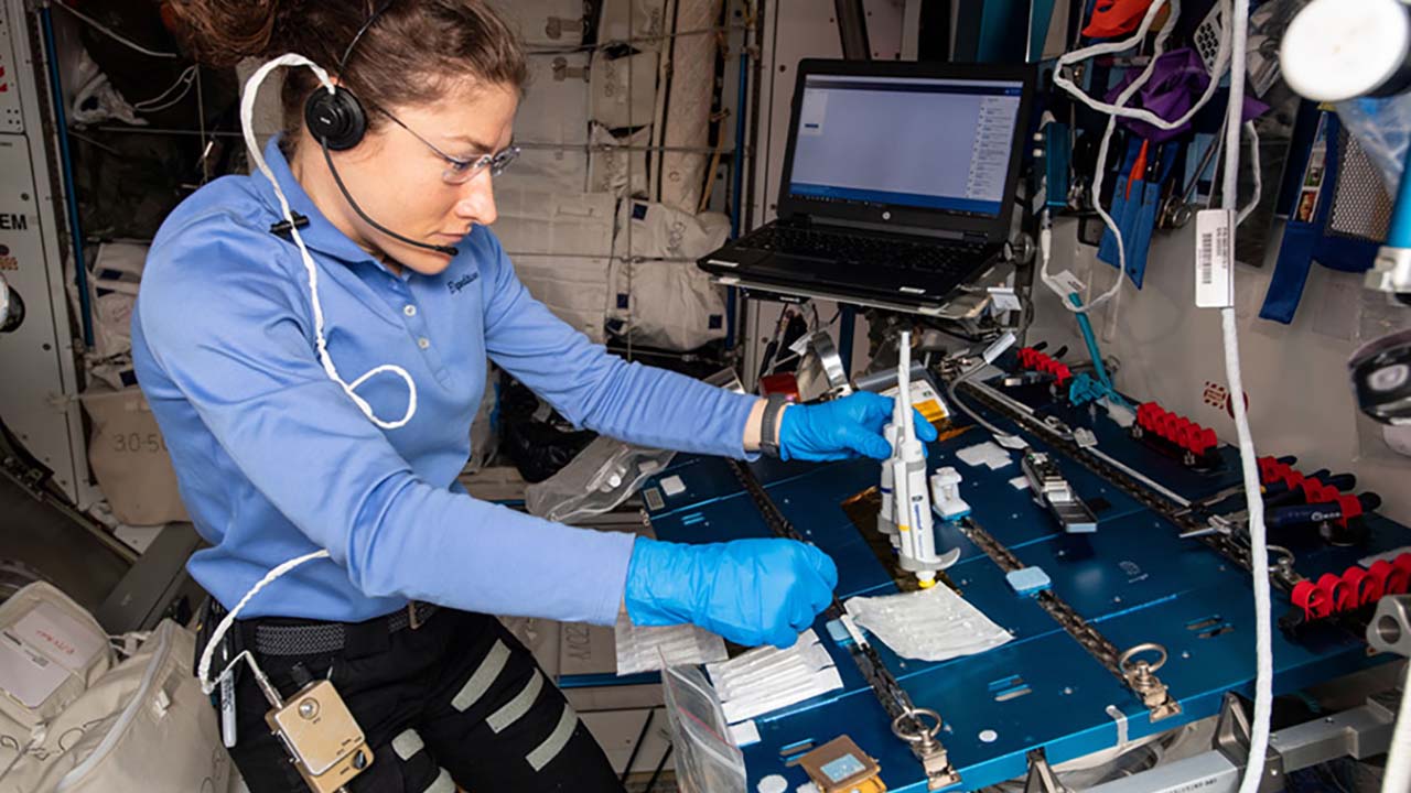 NASA astronaut Christina Koch works on the Genes In Space 6 experiment, which used the Biomolecule Sequencer to sequence DNA samples to help scientists understand how space radiation mutates DNA and assess the molecular level repair process.