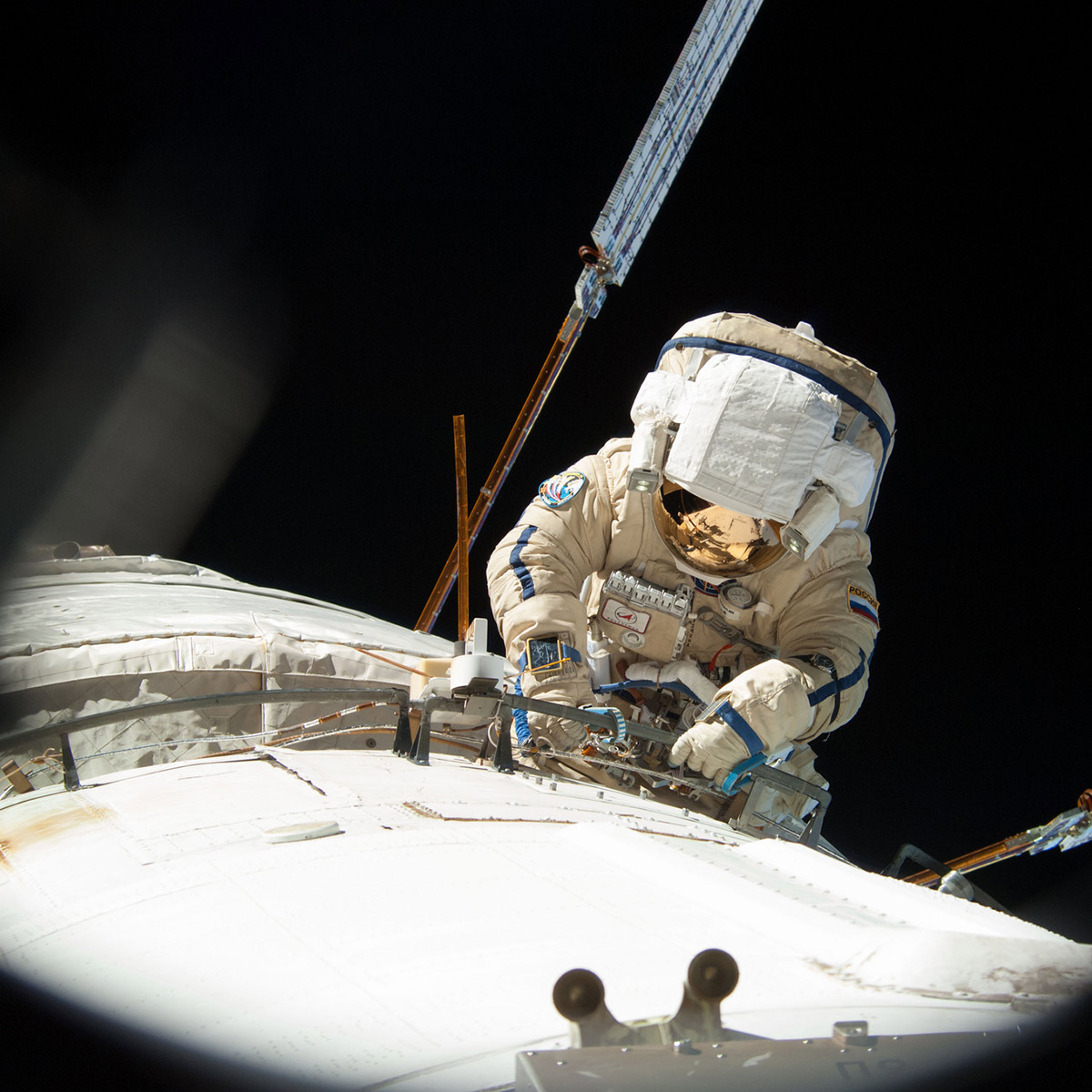 ISS036 E 035133 (22 Aug. 2013) Russian cosmonaut Alexander Misurkin, Expedition 36 flight engineer, attired in a Russian Orlan spacesuit, participates in a session of extravehicular activity (EVA) to continue outfitting the International Space Station. During the five hour, 58 minute spacewalk, Misurkin and Russian cosmonaut Fyodor Yurchikhin (out of frame) completed the replacement of a laser communications experiment with a new platform for a small optical camera system, the installation of new spacewalk aids and an inspection of antenna covers.