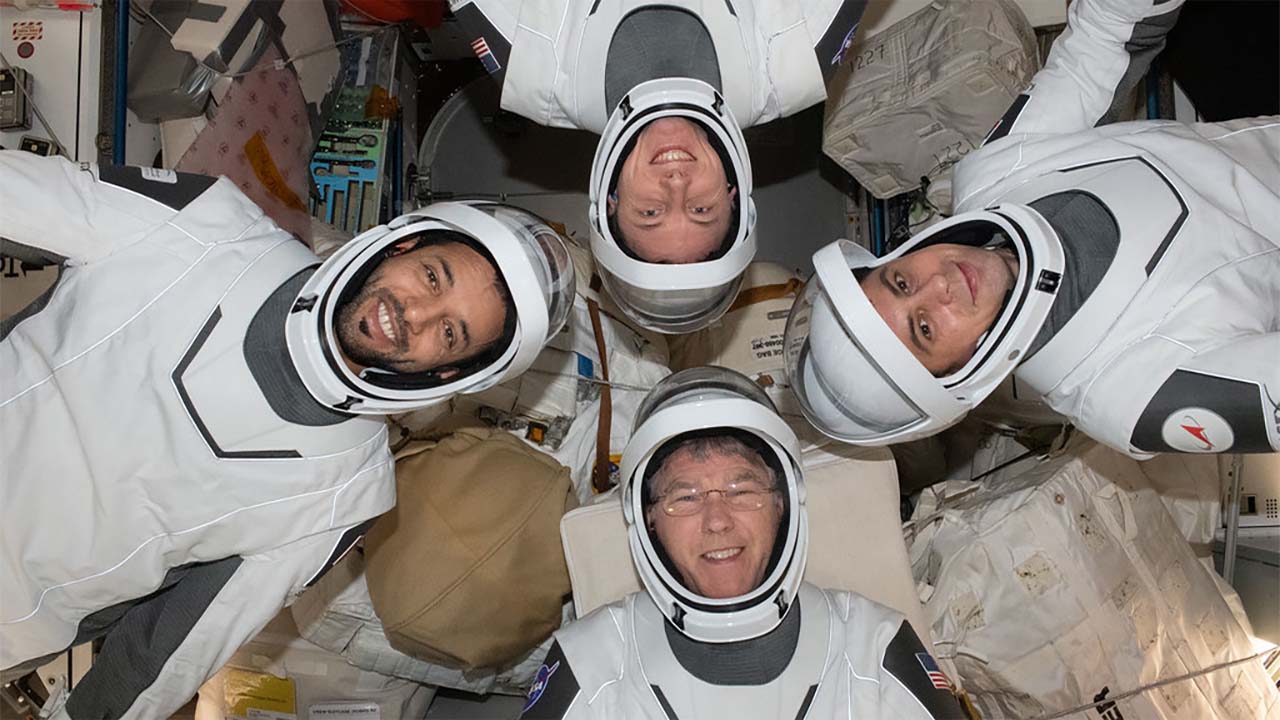 Expedition 69 crewmates pose in SpaceX pressure suits. Clockwise from bottom, are NASA astronaut Stephen Bowen; UAE (United Arab Emirates) astronaut Sultan Alneyadi; NASA astronaut Woody Hoburg; and Roscosmos cosmonaut Andrey Fedyaev.