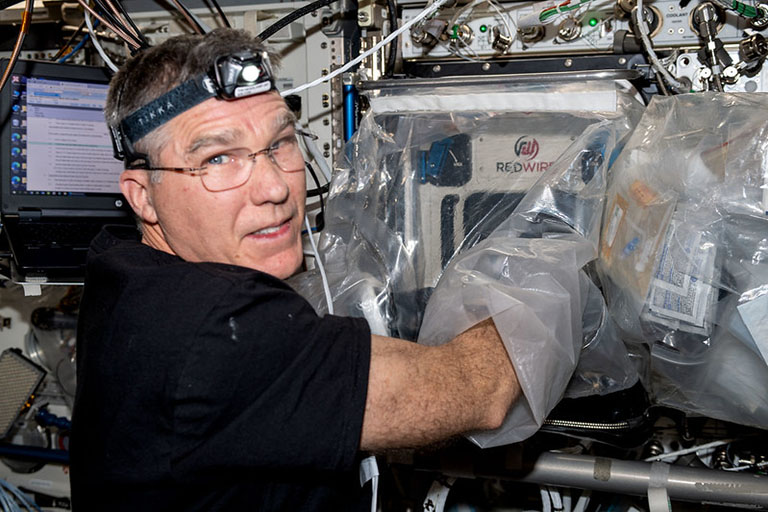 NASA astronaut Stephen Bowen helps with the Biofabrication Facility (BFF) meniscus prints on the ISS.