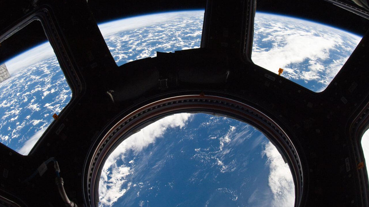 ISS022 E 080014 (3 March 2010) A blue and white part of Earth and its horizon, as seen through the windows in the Cupola, are featured in this image photographed by an Expedition 22 crew member on the International Space Station.