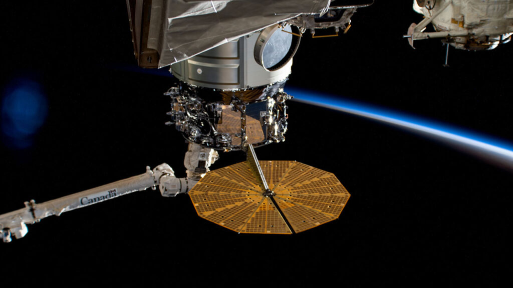 cygnus10year-orbital-sunrise The Northrup Grumman Cygnus space freighter is pictured in the grip of the Canadarm2 robotic in April 2023
