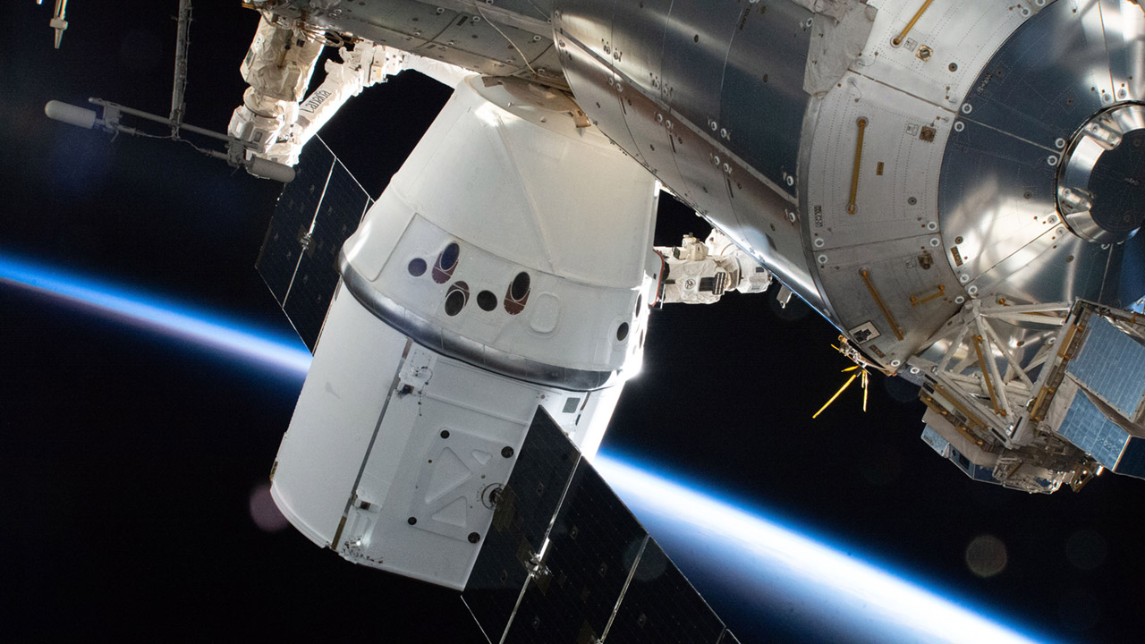 The SpaceX Dragon resupply ship is pictured attached to the Earth facing port on the International Space Stations Harmony module.