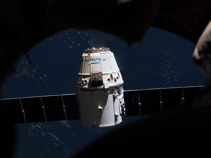iss054e022063 (Jan. 13, 2018) The SpaceX Dragon is pictured from inside the seven windowed cupola moments after ground controllers remotely commanded the Canadarm2 to release it from its grips.