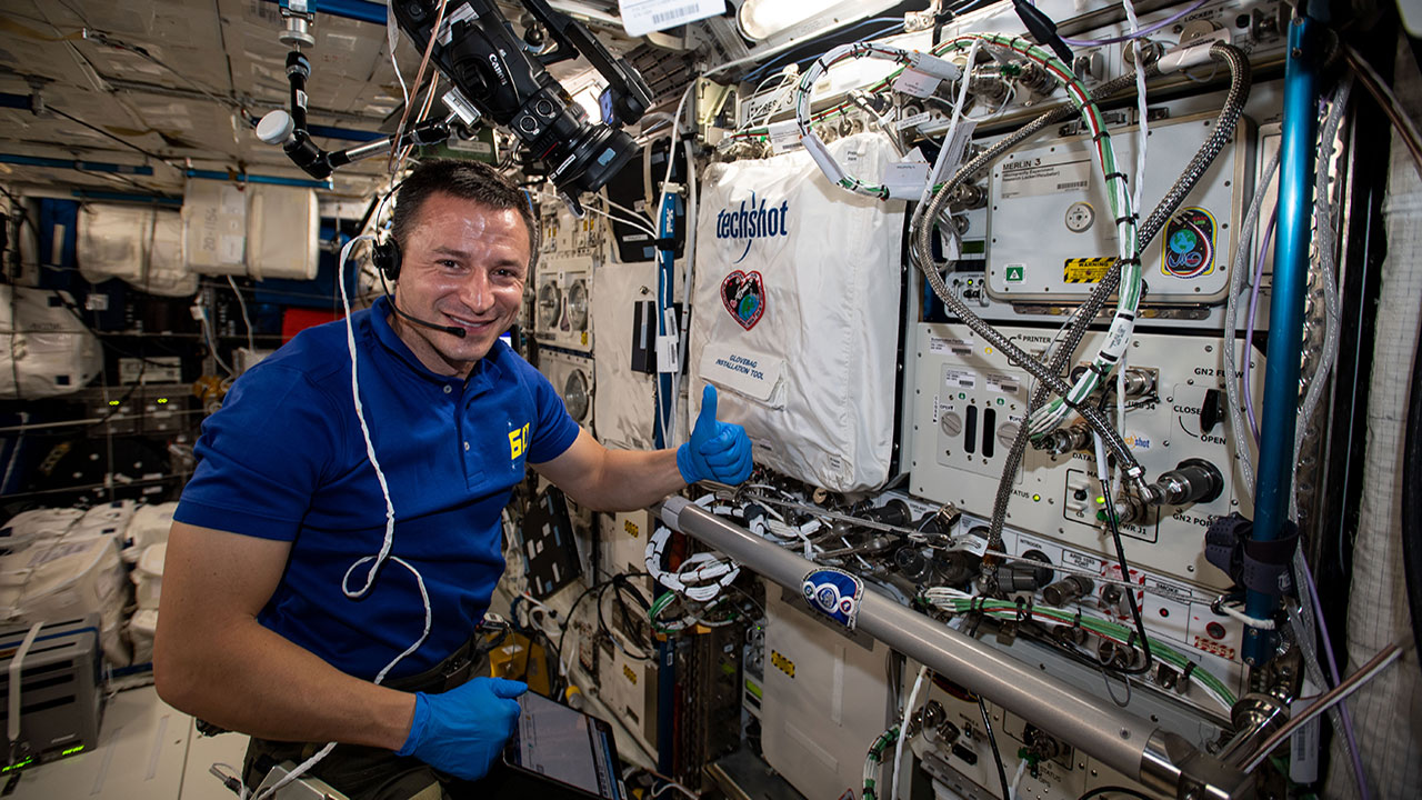 NASA astronaut Andrew Morgan works on setting up the BioFabrication Facility to test print tissues.