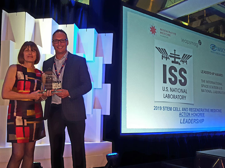 ISS National Lab Board of Directors member Dr. Gordana Vunjak Novakovic and Senior Associate Program Scientist Dr. Marc Giulianotti accept the Leadership Award at the World Stem Cell Summit