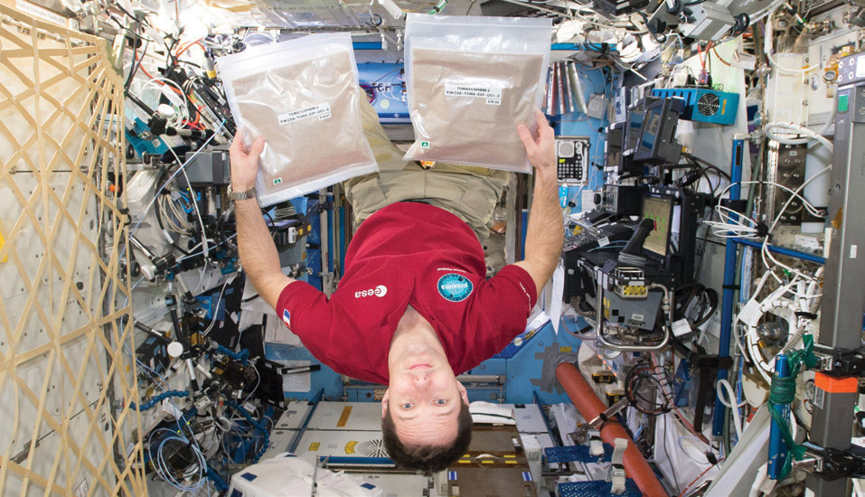 esa astronaut with tomatosphere seed packs