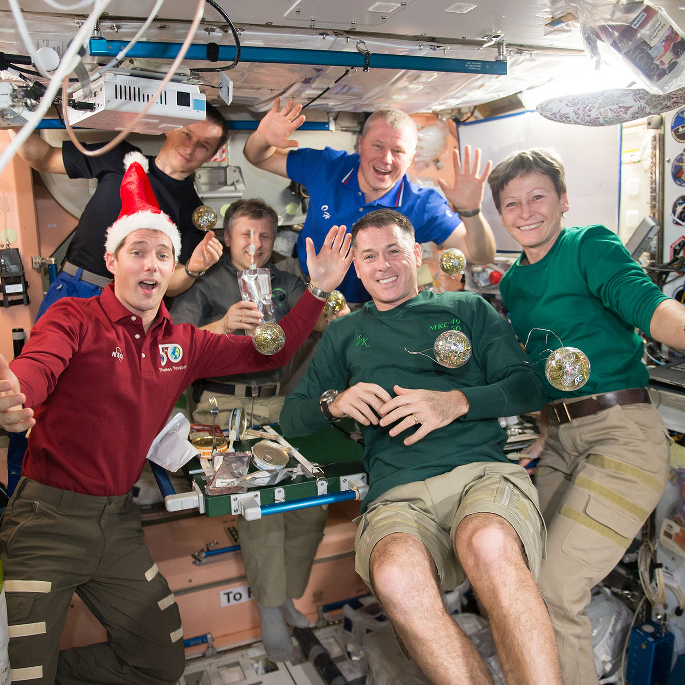 The crew of Expedition 50 gathered together to celebrate the holidays aboard the International Space Station. Front row: Thomas Pesquet of ESA (left) and NASA astronauts Shane Kimbrough (middle) and Peggy Whitson of NASA. Back row: Sergey Ryzhikov (left), Andrei Borisenko (middle), and Oleg Novitskiy (right) of Roscosmos.