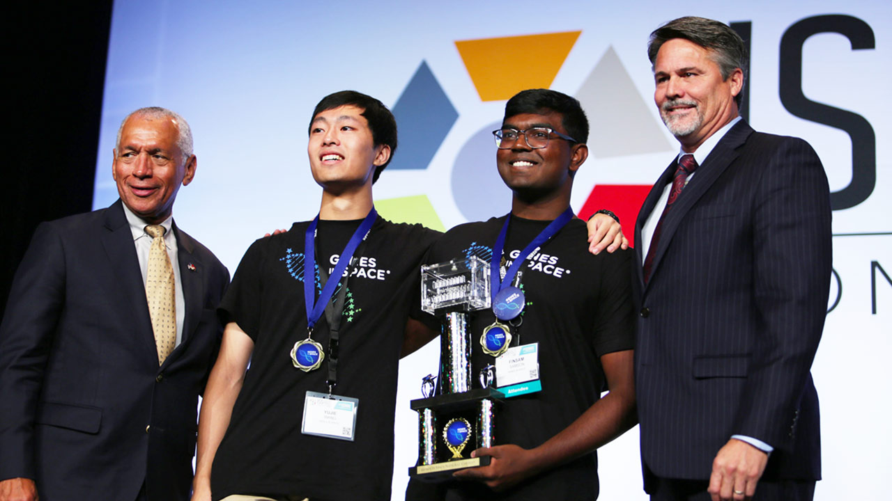 Yujie Wang (second from the left) and Finsam Samson (second from the right) were announced the winners of the 2019 Genes in Space competition at the 2019 ISS Research and Development Conference.