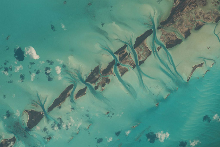 Bahamas, the strokes of your watercolors are always a refreshing sight. Astronaut Scott Kelly, ISS Expedition 43 44 45 46. Great Exuma Island, Bahamas. Zoom in on this photo to find an aircraft and its twin condensation trails.