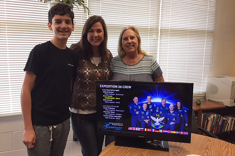Bryce meets with science teacher Tracy Rossi and Principal Sherryl Loya at Farmwell Station Middle School.