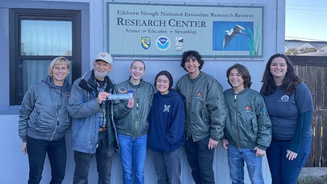 Team Yucca Glauca students and their mentors at the Elkhorn Slough National Estuarine Research Reserve to conduct their postflight analysis. (Pictured from left to right: iLEAD Director of STEAM Initiatives Kathleen Fredette; retired Elkhorn Slough Reserve Director of Education Kenton Parker; Team Yucca Glauca students Grace Stumppf, Emilini Walker, Carter Sand, and Hutch Siegen; and iLEAD STEAM Program Specialist Shawna Melville.)