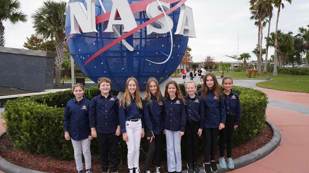Team Seagrass at Kennedy Space Center in November 2022, when they presented their experiment. From left to right: Maya Cohen, Enzo Cosio, Teya Brandes, Sadie Halvorsen, Caydin Brandes, Jersey Holeman, Naya Berman, and Peyton Pelletier