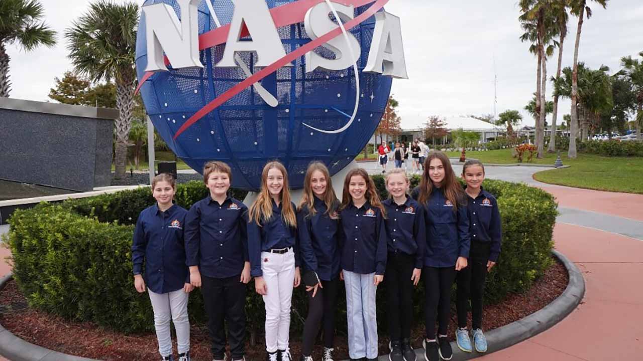 Team Seagrass at Kennedy Space Center in November 2022, when they presented their experiment. From left to right: Maya Cohen, Enzo Cosio, Teya Brandes, Sadie Halvorsen, Caydin Brandes, Jersey Holeman, Naya Berman, and Peyton Pelletier