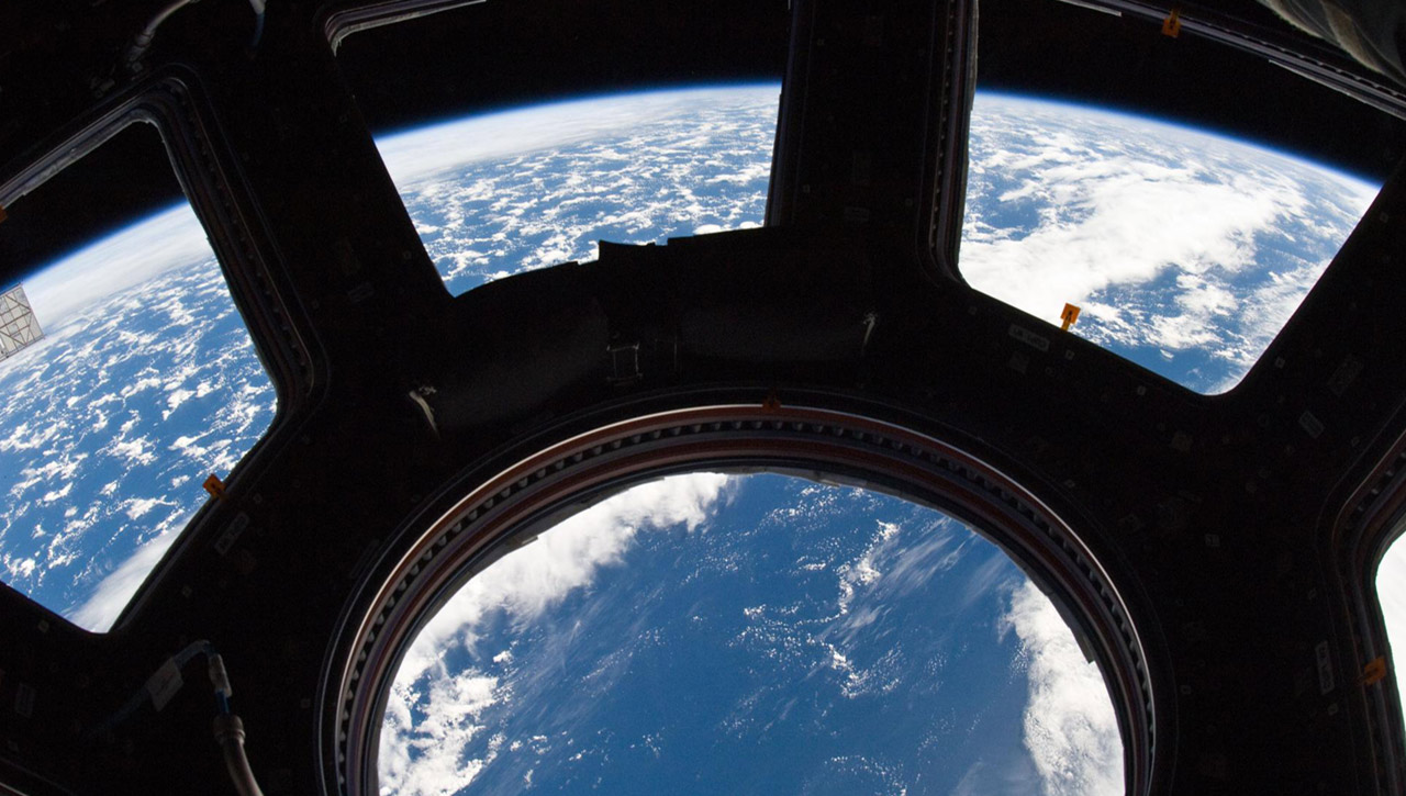 SS022 E 080014 (3 March 2010) A blue and white part of Earth and its horizon, as seen through the windows in the Cupola, are featured in this image photographed by an Expedition 22 crew member on the International Space Station.