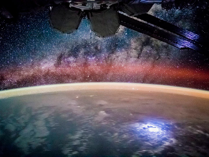An astronaut took this broad, short lens photograph of Earths night lights while looking out over the remote reaches of the central equatorial Pacific Ocean. The ISS was passing over the island nation of Kiribati at the time, about 2600 kilometers (1,600 miles) south of Hawaii. The curvature of the Earth crosses the center of the image and is illuminated by a variety of airglow layers in orange, green, and red. Setting stars are visible even through the dense orange green airglow.