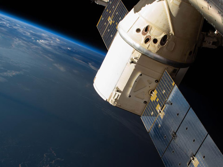 The SpaceX Dragon cargo craft is pictured attached to the International Space Stations Harmony module as the orbital complex flew 258 miles above the Indian Ocean off the eastern coast of South Africa.