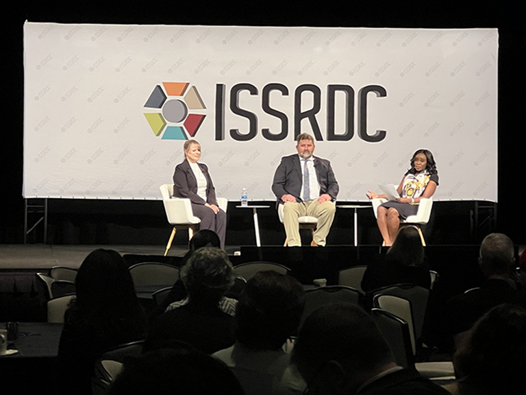 Ezinne Uzo Okoro, assistant director for space policy at the White House Office of Science and Technology Policy, moderates a panel discussion at ISSRDC 2023 on Igniting Innovation to Accelerate Disease Research on the ISS. She was joined by panelists Michael Roberts, chief scientific officer for the ISS National Lab, and Lisa Carnell, Biological and Physical Science Division director at NASA.