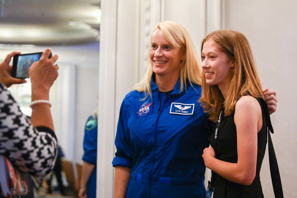 NASA Astronaut Kate Rubins poses for a photo with a conference attendee.