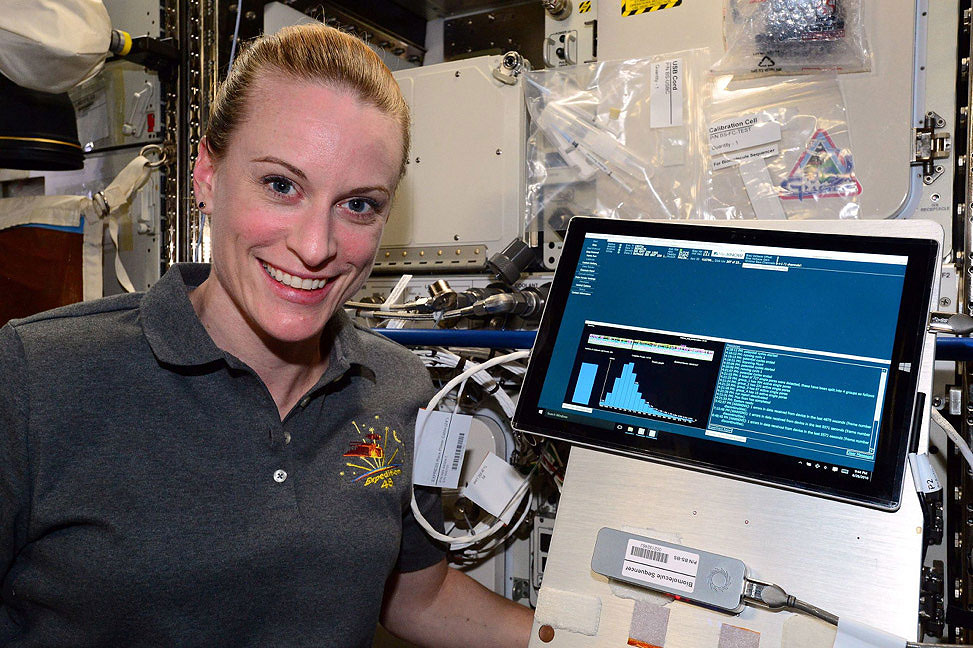 Rubins is pictured onboard the ISS with the USB MinION sequencer (lower right), created by Oxford Nanopore Technologies, and was used in the first ever DNA sequencing in space in August 2016.