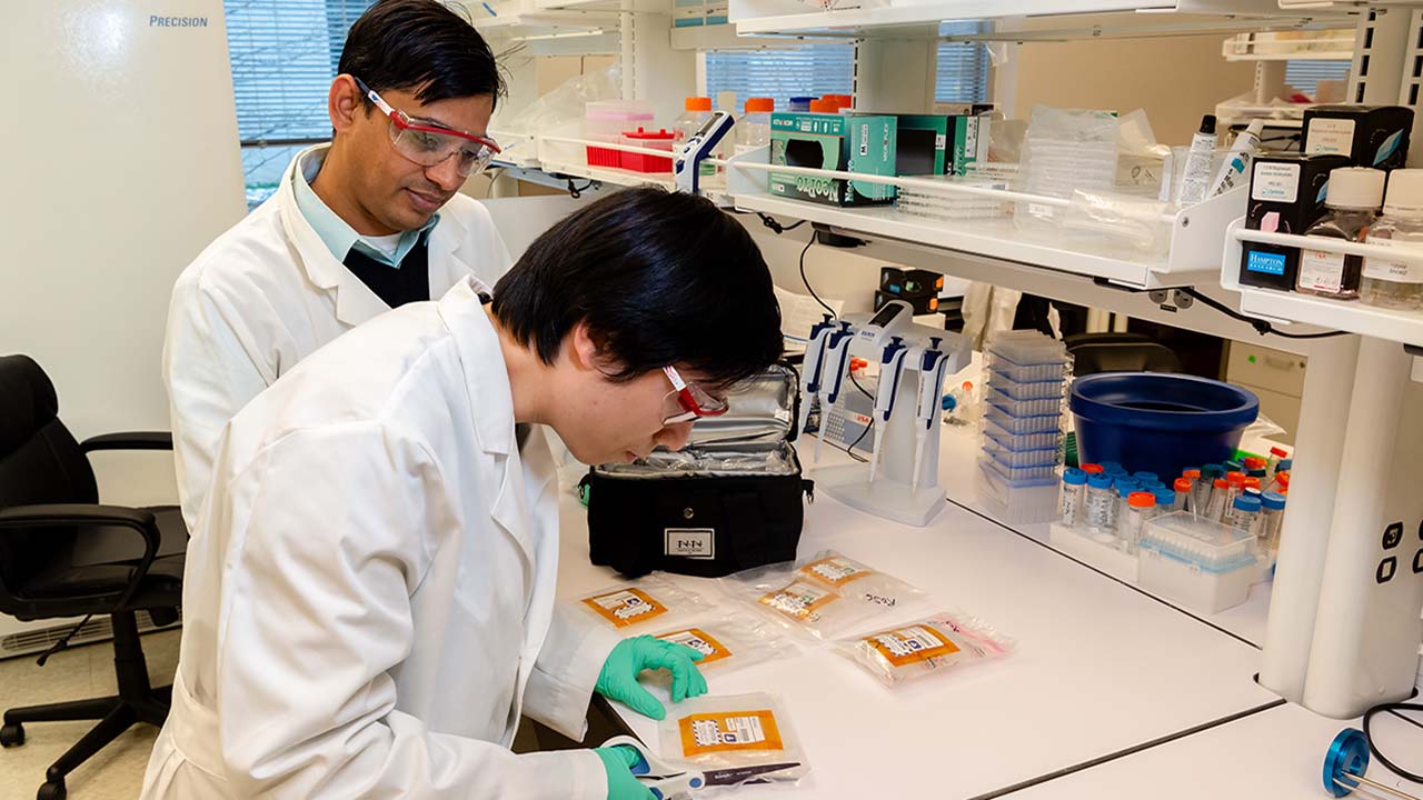 The Frederick National Lab team carefully opening samples returned from the ISS