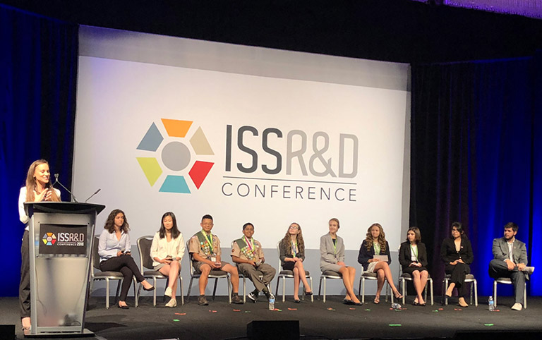Emily Calandrelli (left) moderates a panel of students who have sent experiments to the ISS.