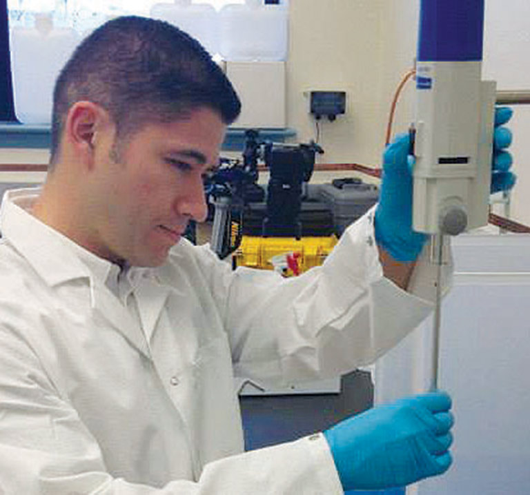 Dr. Luis Zea preparing the AES 1 experiment at Kennedy Space Center prior to the launch of Orbital ATK CRS 1.
