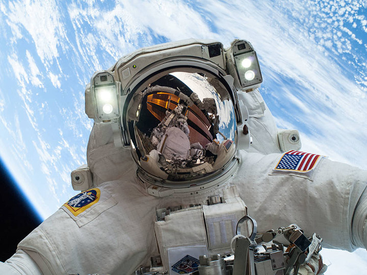 On Dec. 24, 2013, NASA astronaut Mike Hopkins, Expedition 38 Flight Engineer, participates in the second of two spacewalks, spread over a four day period, which were designed to allow the crew to change out a degraded pump module on the exterior of the Earth orbiting International Space Station. He was joined on both spacewalks by NASA astronaut Rick Mastracchio, whose image shows up in Hopkins helmet visor.