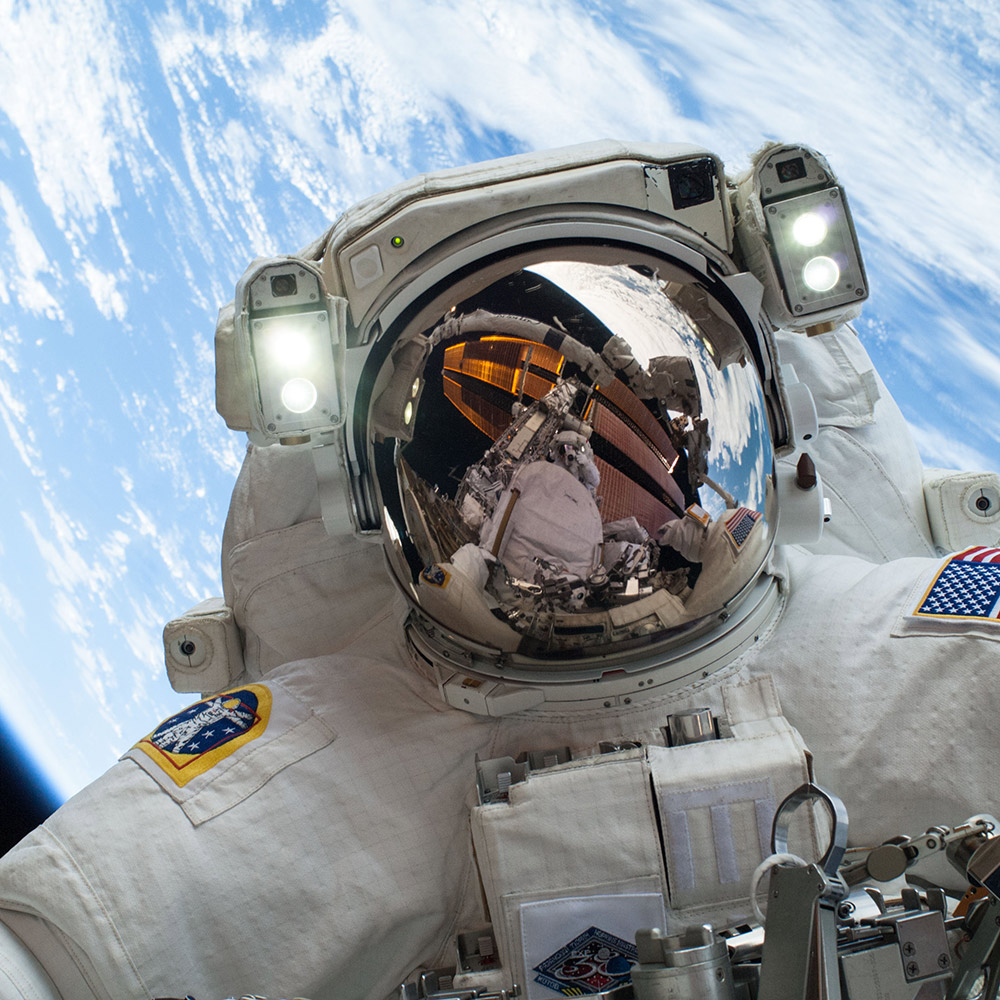 On Dec. 24, 2013, NASA astronaut Mike Hopkins, Expedition 38 Flight Engineer, participates in the second of two spacewalks, spread over a four day period, which were designed to allow the crew to change out a degraded pump module on the exterior of the Earth orbiting International Space Station. He was joined on both spacewalks by NASA astronaut Rick Mastracchio, whose image shows up in Hopkins helmet visor.